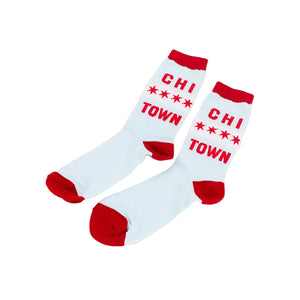 A pair of white crew socks with red heels, toes, and cuffs, featuring the red text 'CHI TOWN' and red stars printed on the sides, displayed on a clean white background.