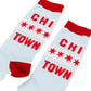 A pair of light blue crew socks with red cuffs, heels, and toes, featuring the red text 'CHI TOWN' and the four-star logo design from the Chicago flag on a white background.