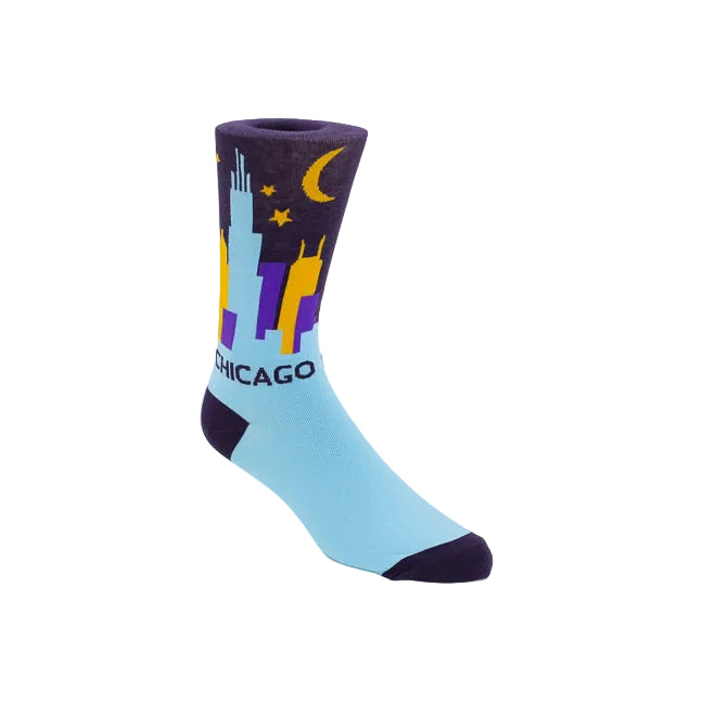 A single crew sock with a light blue body, dark purple toe and cuff, and a colorful Chicago skyline graphic on the upper leg. The word 'CHICAGO' is printed in black near the ankle.