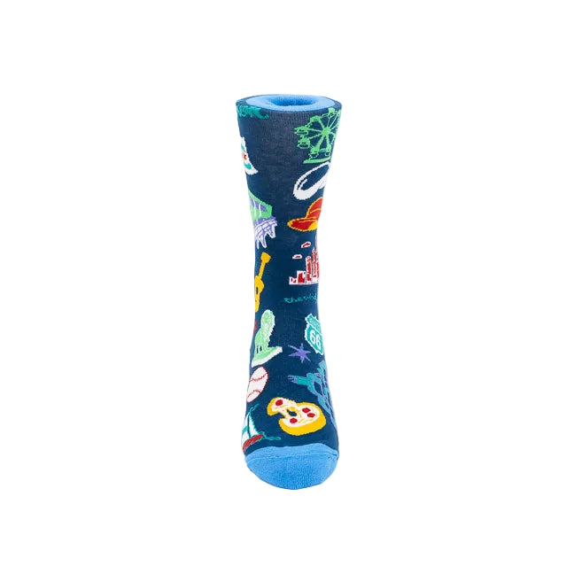 A single crew sock with a dark navy blue background and a colorful pattern of various illustrated objects, including a Ferris wheel, a fedora, a Ferris Wheel, a lion statue, and pizza slice, shown on a plain white background.