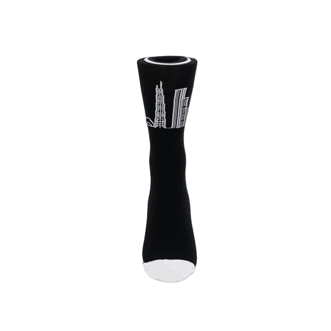 A single black sock displayed on a white form against a light gray background, featuring a white graphic of skyscrapers on the side and a white toe.