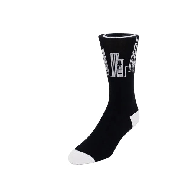 A single black crew sock with a white graphic print of skyscrapers on the upper leg, finished with a white toe and heel, shown against a plain white background.