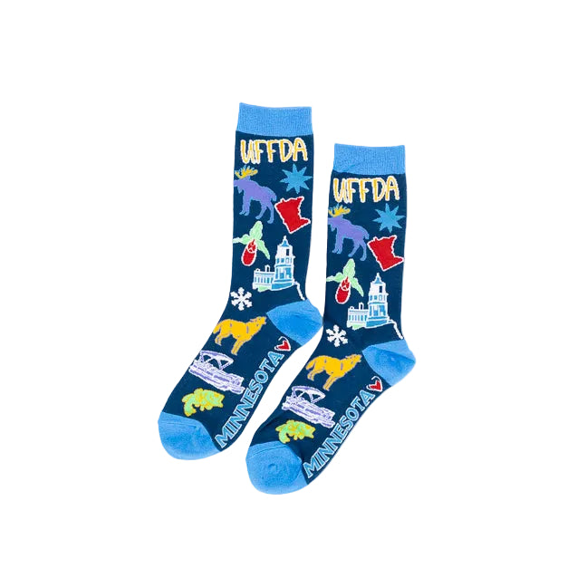 A pair of crew socks with a dark blue background featuring colorful illustrations of Minnesota landmarks, animals, and the word 'UFFDA' in yellow, with bright blue heels, toes, and cuffs.