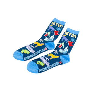 A pair of crew socks with a dark blue background featuring colorful illustrations of Minnesota landmarks, animals, and the word 'UFFDA' in yellow, with bright blue heels, toes, and cuffs.