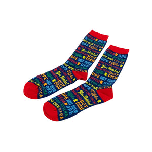 A pair of tall socks with a colorful retro pattern of 'OPE', 'HOT DISH', 'UFF DA', and 'YOU BETCHA' text on a white background.
