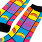 A pair of colorful crew socks with a bold geometric pattern of pink, yellow, blue, and orange squares, featuring stylized lips and the text 'the BEAN' in pink on purple blocks, with black ribbed cuffs and heels.