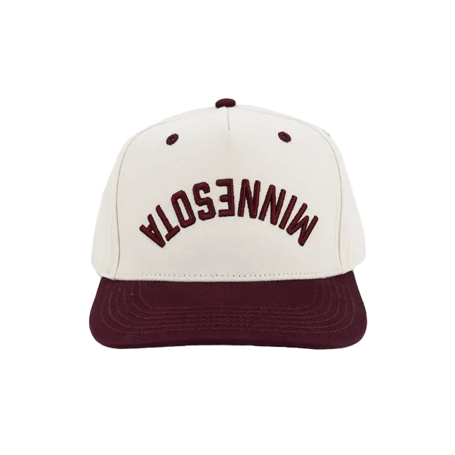 A structured baseball cap with an off-white crown and a dark maroon flat brim. The front of the crown features the word 'MINNESOTA' backwards and upside down embroidered in arched maroon lettering.