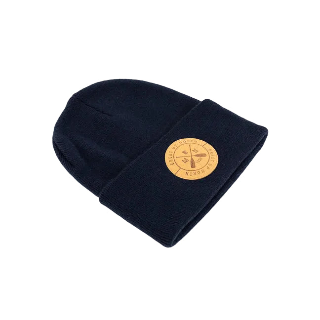 A Navy blue knit beanie hat with a folded cuff, featuring a circular tan leather patch on the front with crossed oars and the text 'GREAT UP NORTH' set against a white background.