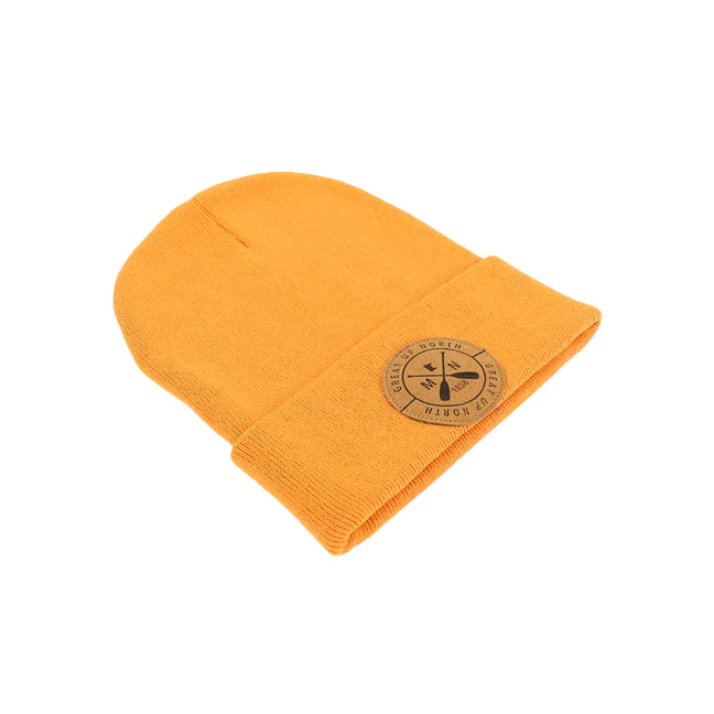 An orange knit beanie hat with a folded cuff, featuring a circular tan leather patch on the front with crossed oars and the text 'GREAT UP NORTH' set against a white background.