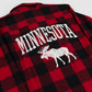 A close-up of a red and black buffalo plaid flannel shirt, showing the back side with a distressed white graphic that reads 'MINNESOTA' above a white moose silhouette.