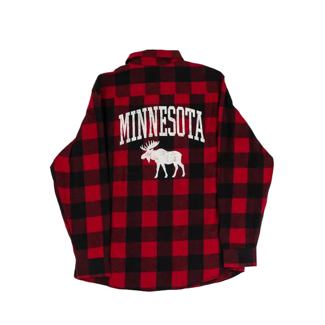 A red and black buffalo plaid flannel shirt shown from the back, featuring 'MINNESOTA' in white varsity-style letters above a white moose graphic, laid flat on a light gray background.