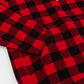 A close-up of red and black buffalo plaid fabric with a visible stitched pocket, laid flat on a white background.