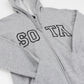 A close-up of a sport gray zip-up hoodie with 'SOTA' embroidered in black varsity-style block letters across the chest, shown on a plain white background.