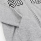Close-up of a sport gray zip-up hoodie with black outlined varsity-style lettering across the chest and the sleeve tucked inside a front pocket.