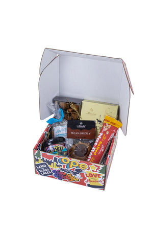 Box of assorted snacks and candies on a white background