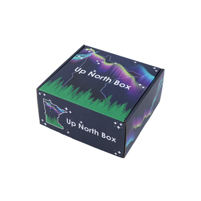 Up North Box packaging with forest and night sky design on a white background