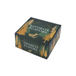 A Minnesota-themed gift box in green and yellow/orange hues featuring trees, branches a loon and the words Favorite Flavors.