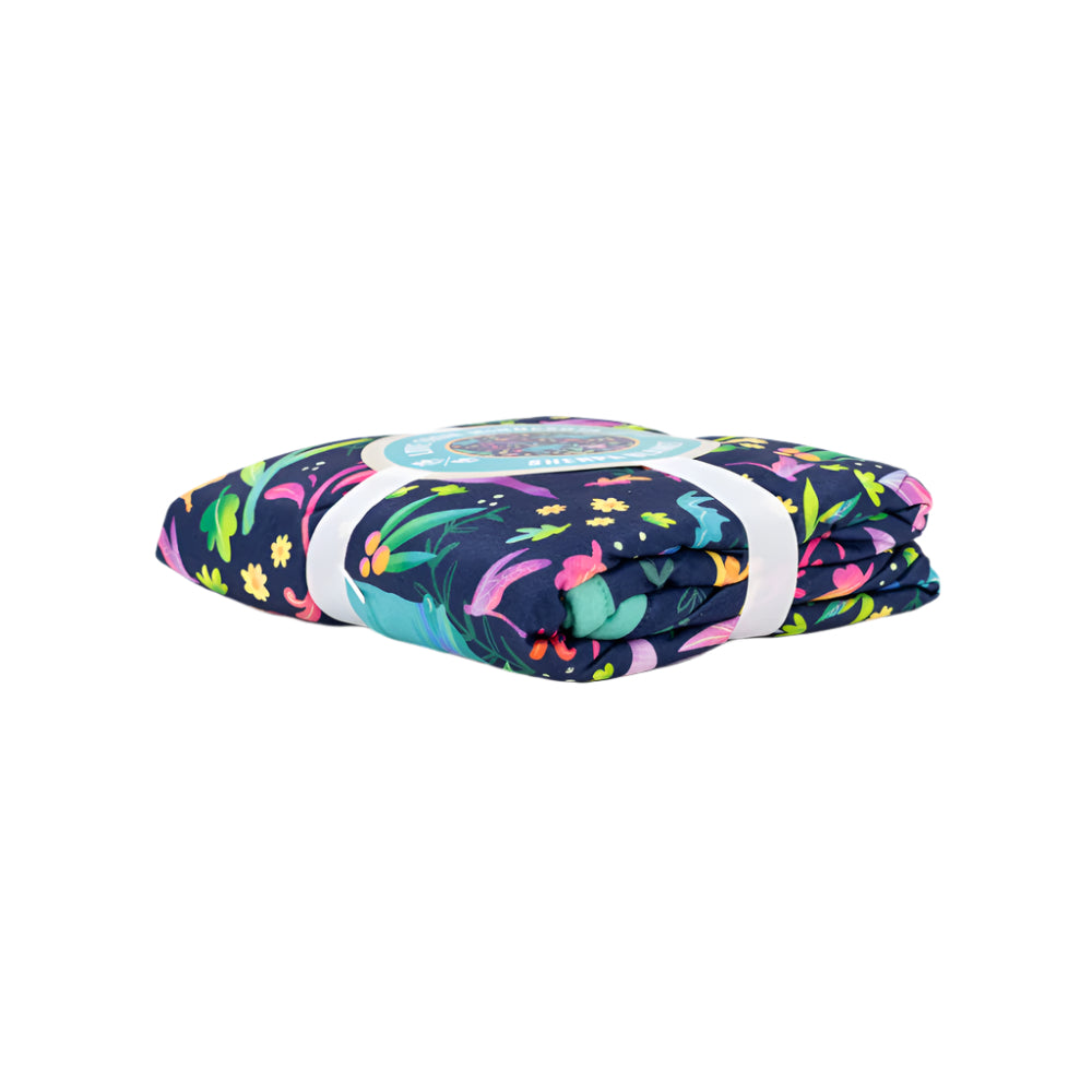 Folded blanket with colorful animal pattern and a label on a white background