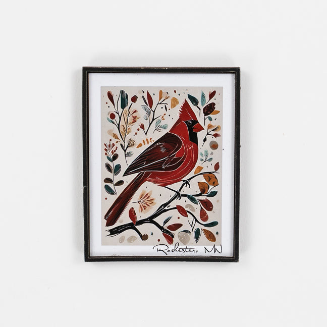 Framed artwork of a red bird on a branch with leaves and flowers on a white background