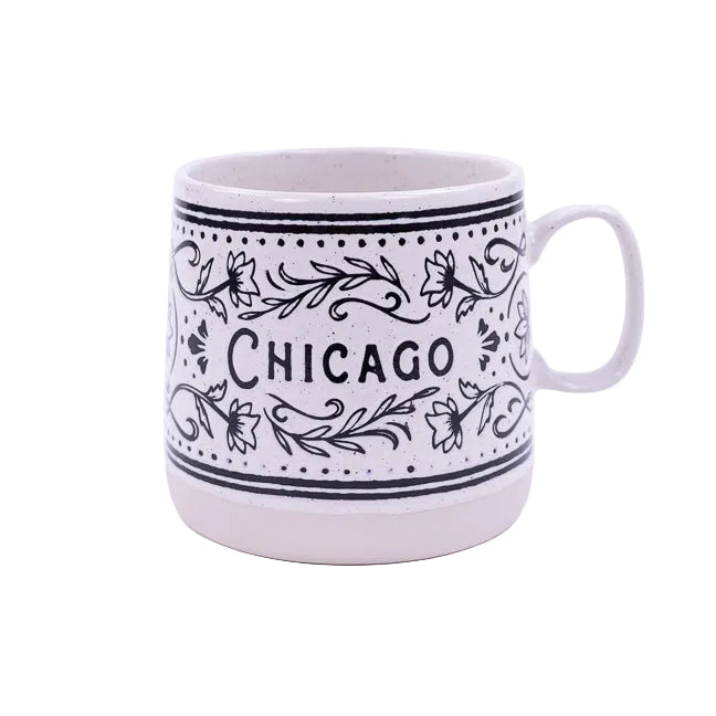 White mug with black floral patterns and 'Chicago' text on a white background