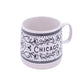 White mug with black floral patterns and 'Chicago' text on a white background