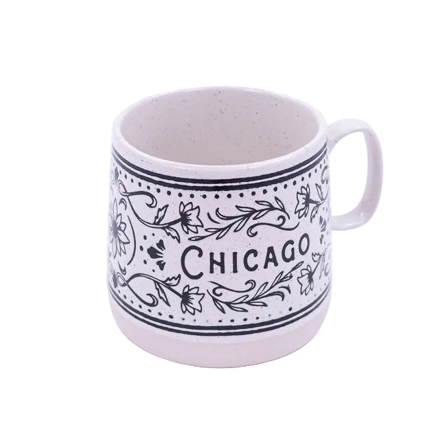 White mug with black floral patterns and 'Chicago' text on a white background