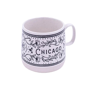 White mug with black floral patterns and 'Chicago' text on a white background