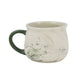 Marble-patterned mug with green handle and Minnesota-themed design on a white background