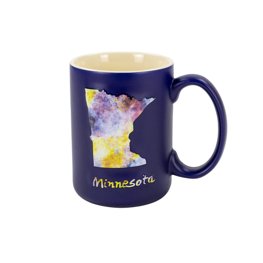 A blue mug with the Minnesota state shape in watercolor design and the word Minnesota in water color print underneath.
