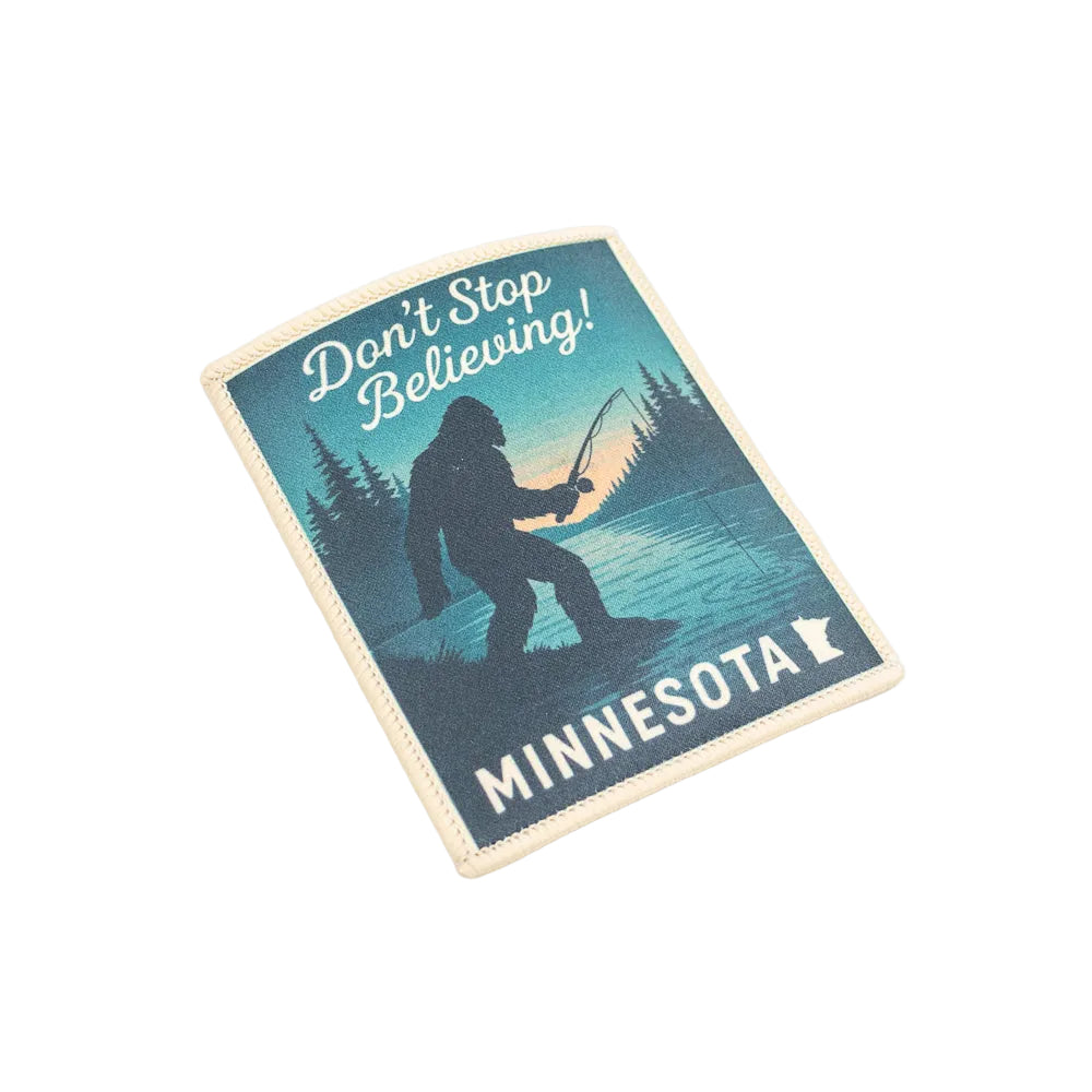 Patch with a silhouette of Bigfoot fishing, text 'Don't Stop Believing! Minnesota', and a state outline on a white background.