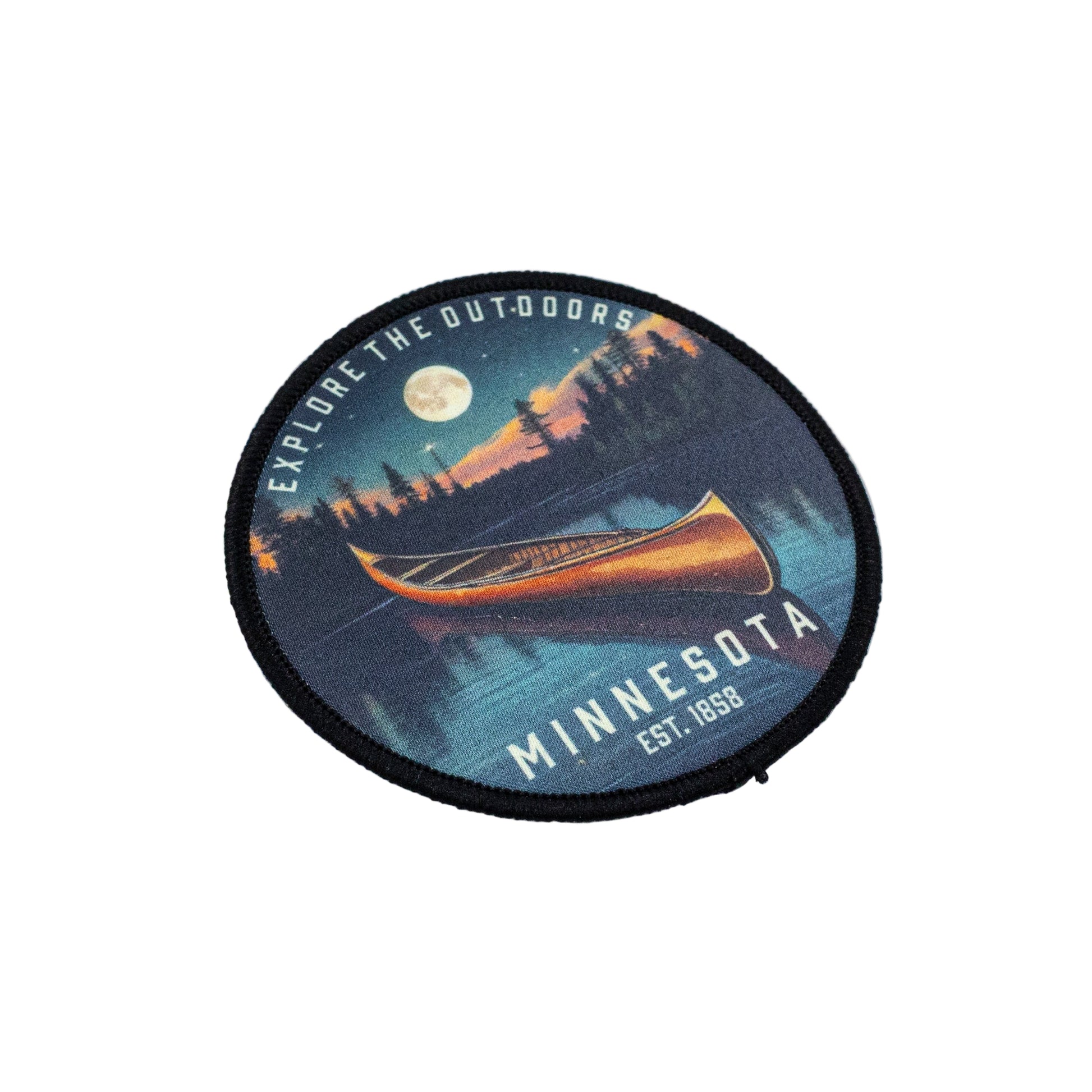 Round patch with a canoe design and 'Explore the Outdoors Minnesota Est. 1858' text set against a white background