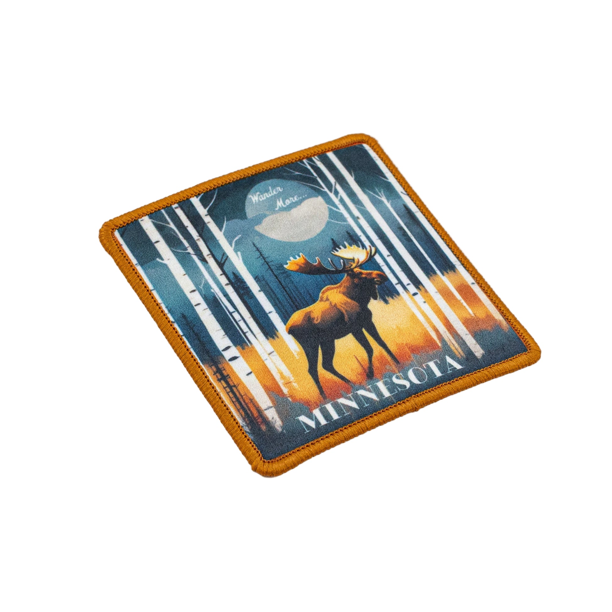 Patch with a moose in a forest design and 'Minnesota' and 'Wander More' text on a white background.