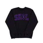 A black crewneck sweatshirt featuring the word 'SKOL' printed across the chest in purple varsity-style block letters, with the letter 'O' designed as a football.