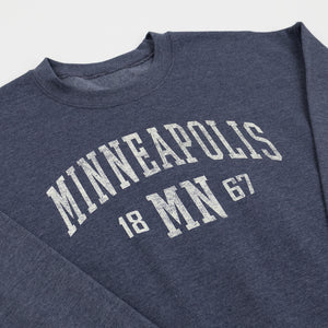 Blue sweatshirt with 'Minneapolis 1867' text on a white background