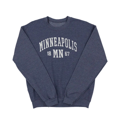 Navy blue sweatshirt with 'Minneapolis 1867' text on a white background