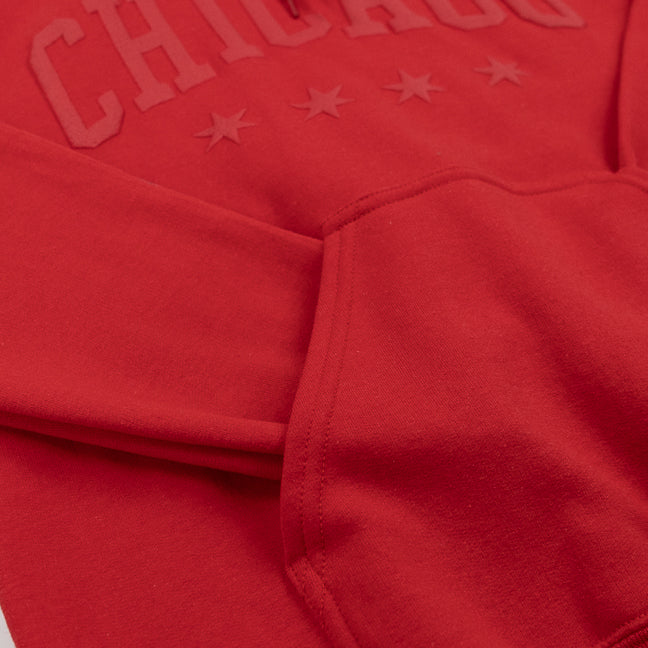 Close-up of a red hoodie with 'Chicago' text and star designs.
