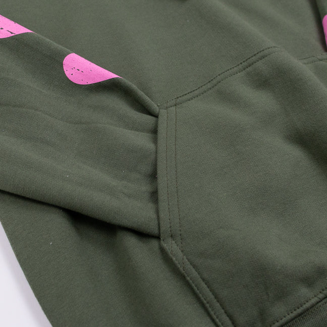 Close up of a green sweatshirt, the sleeve inside a front pocket.