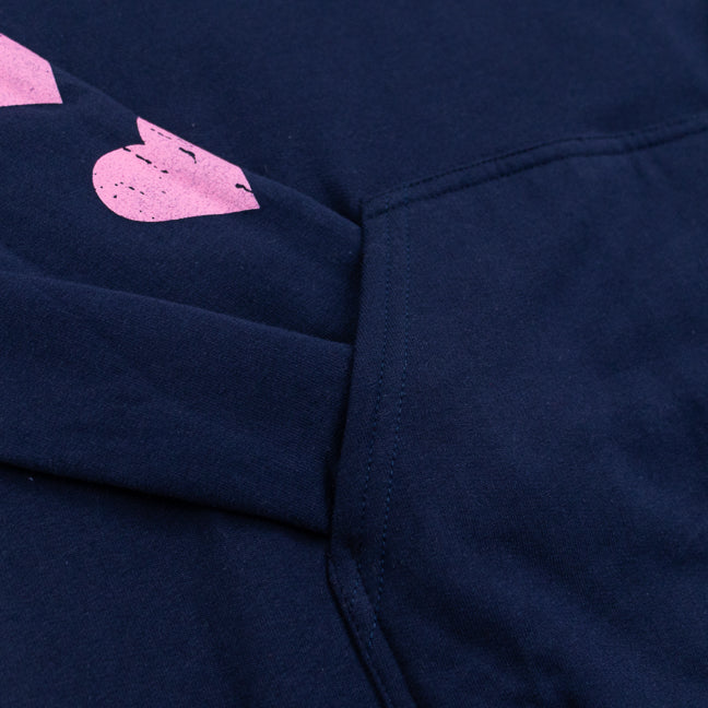 Close up of a sleeve inside a front pocket of a navy blue sweatshirt.