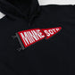 A close-up of a black hoodie featuring a red and white embroidered pennant patch on the chest with the text 'MINNE SOTD'.