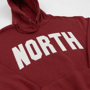 Maroon hoodie with 'NORTH' printed in white on a white background