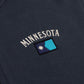 Navy sweatshirt with 'MINNESOTA' text and a flag patch on a dark background