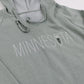 Sage green hoodie with 'MINNESOTA' text and a wildflower on a white background