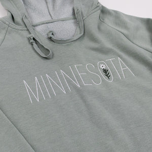 Sage green hoodie with 'MINNESOTA' text and a wildflower on a white background