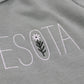 Embroidered text on a sage green fabric with floral design