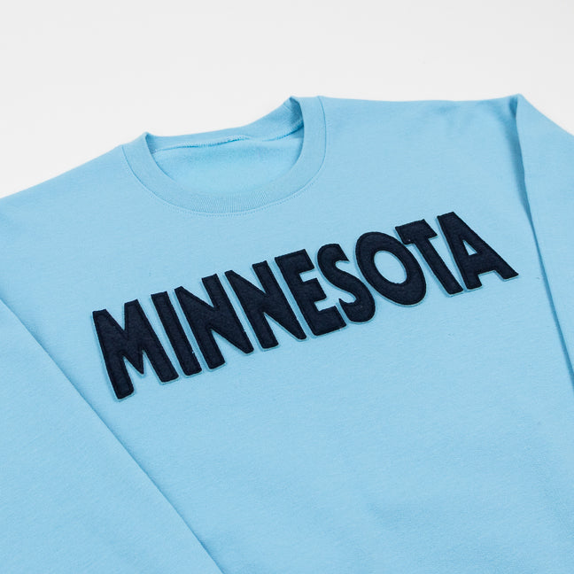 Light blue sweatshirt with 'MINNESOTA' text on a white background
