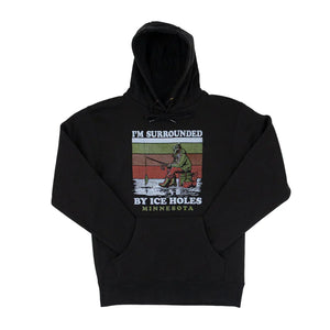 A black sweatshirt featuring a wintry ice fishing scene. Text reads "I'm surrounded by Ice Holes" and "Minnesota."