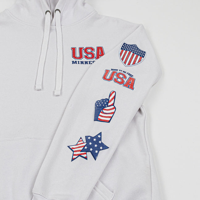 White hoodie with USA-themed patches on a white background