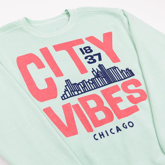 Mint Green sweatshirt with pink text 'CITY VIBES 1837 CHICAGO' and a city skyline design on a white background
