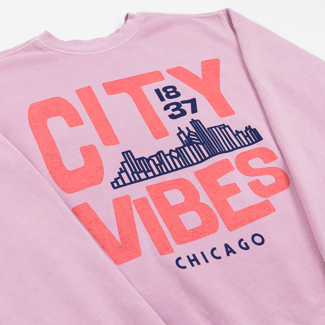 Pink sweatshirt with pink text 'CITY VIBES 1837 CHICAGO' and a city skyline design on a white background