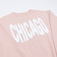 Sage green sweatshirt with 'CHICAGO' printed in white bouncy letters on a white background